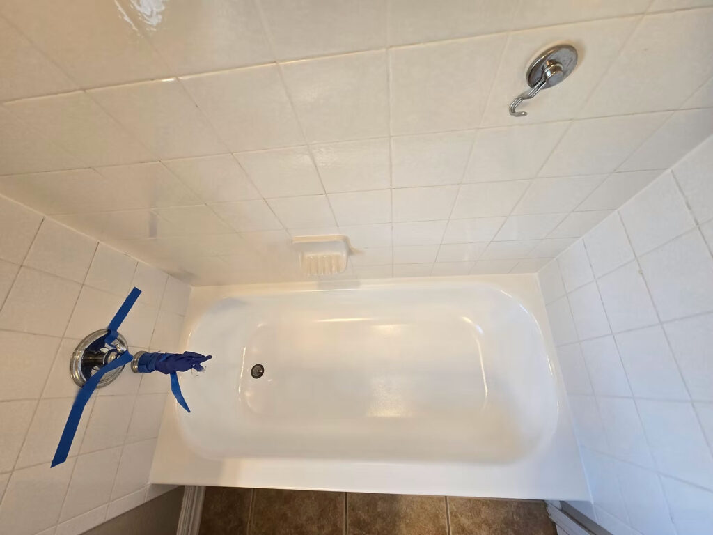 Eye level view of a bathtub being refinished by a local technician