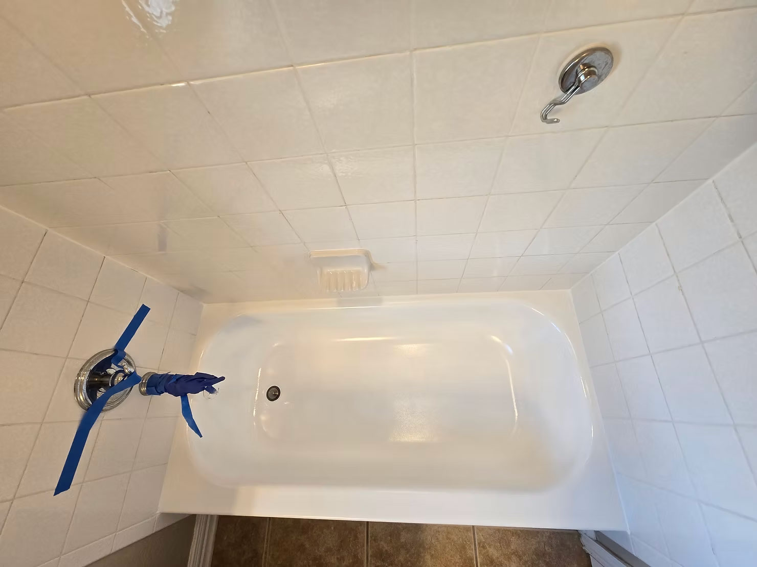 Eye level view of a bathtub being refinished by a local technician